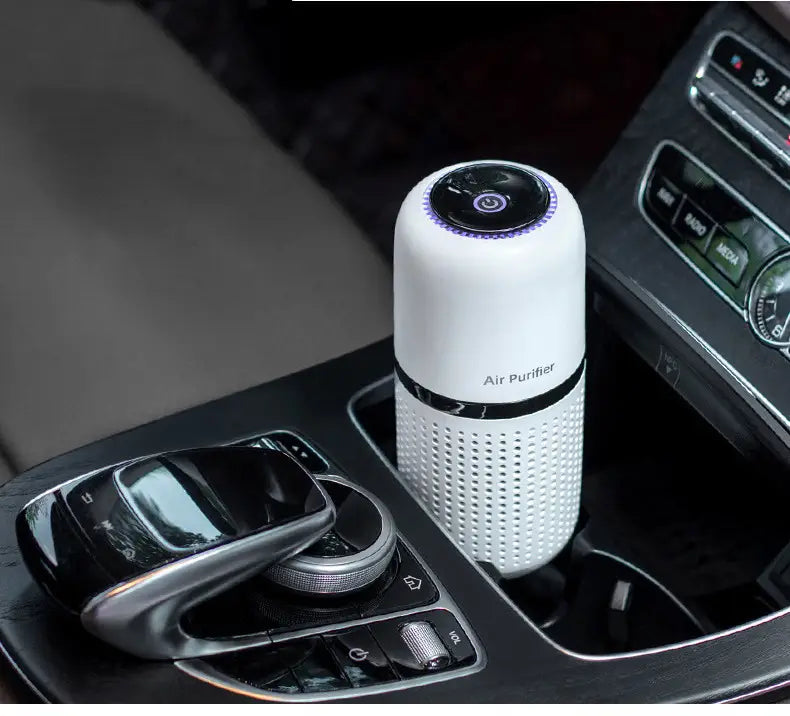 Cylindrical white car air purifier in cup holder using negative ion technology to eliminate formaldehyde