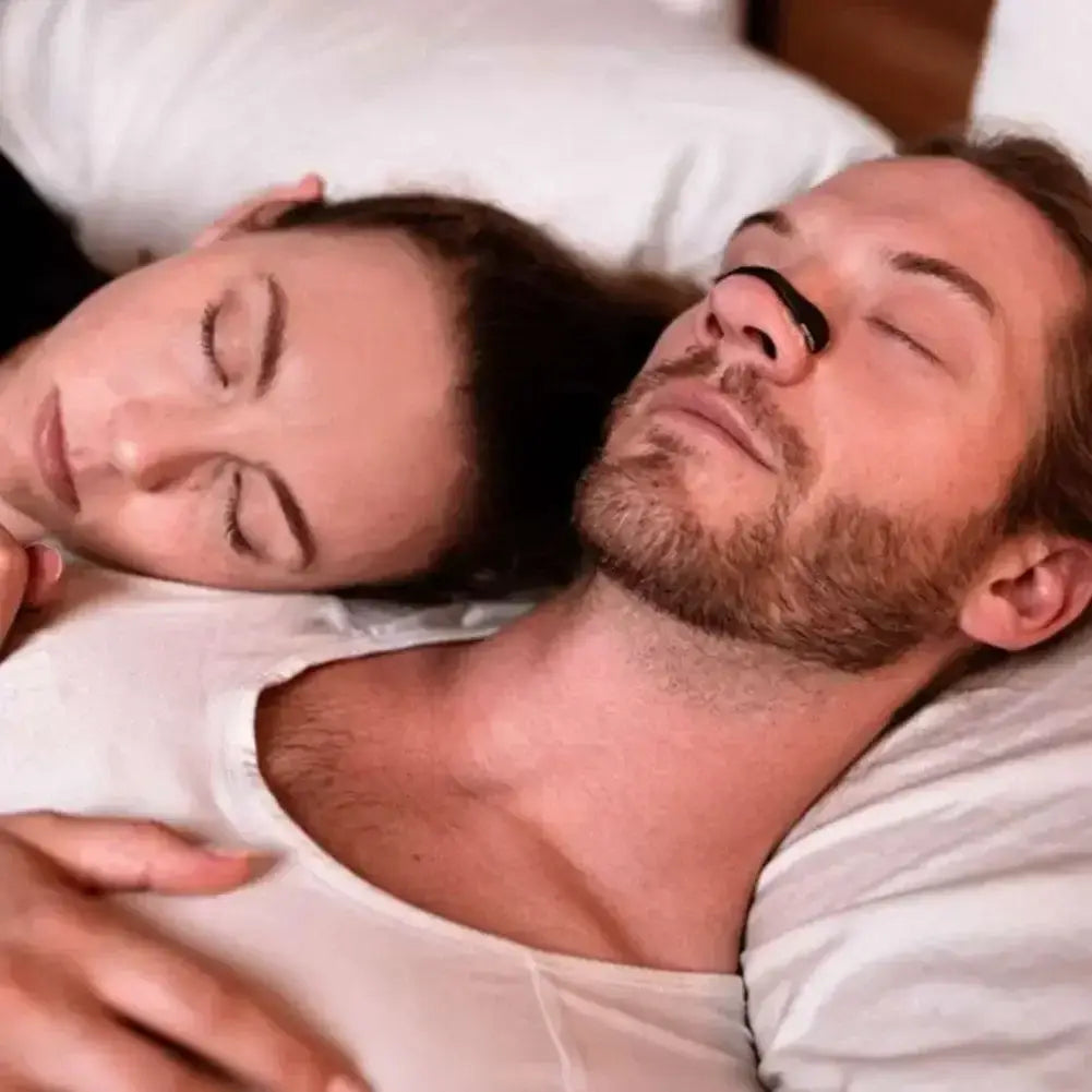 Couple sleeping peacefully with magnetic nasal strips for enhanced sleep quality.