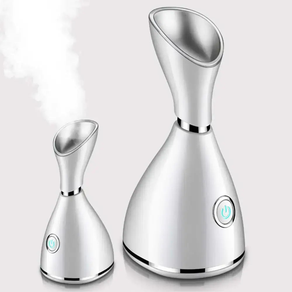 Sleek silver Nano Ionic Facial Steamer with curved tops and circular buttons for hot steam facial.