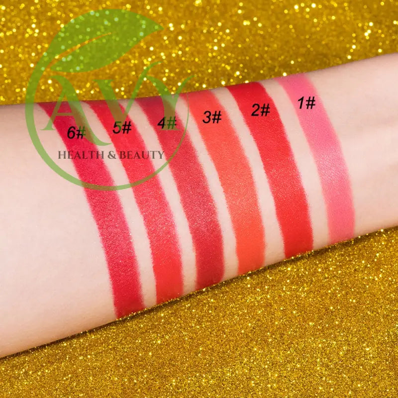 Arm swatches of gold lipstick shades on glitter